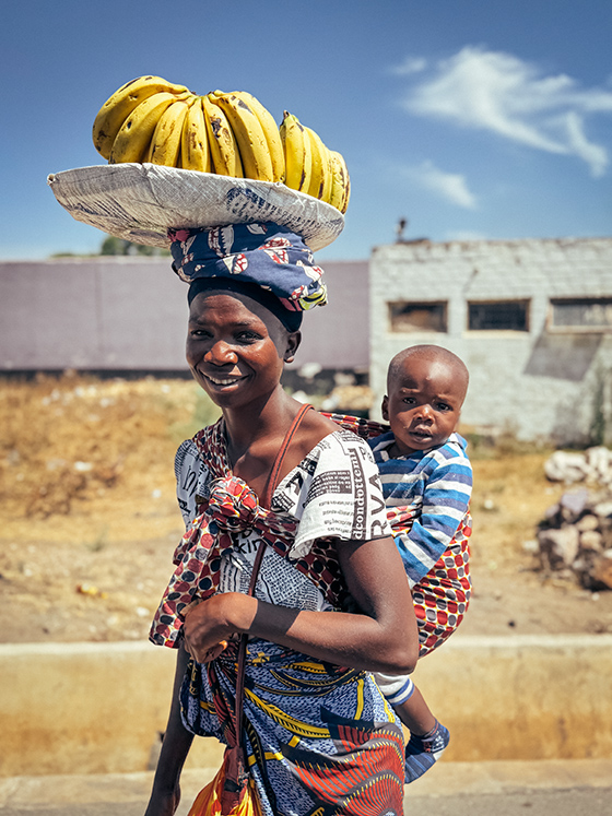 woman with child and bananas in zambia